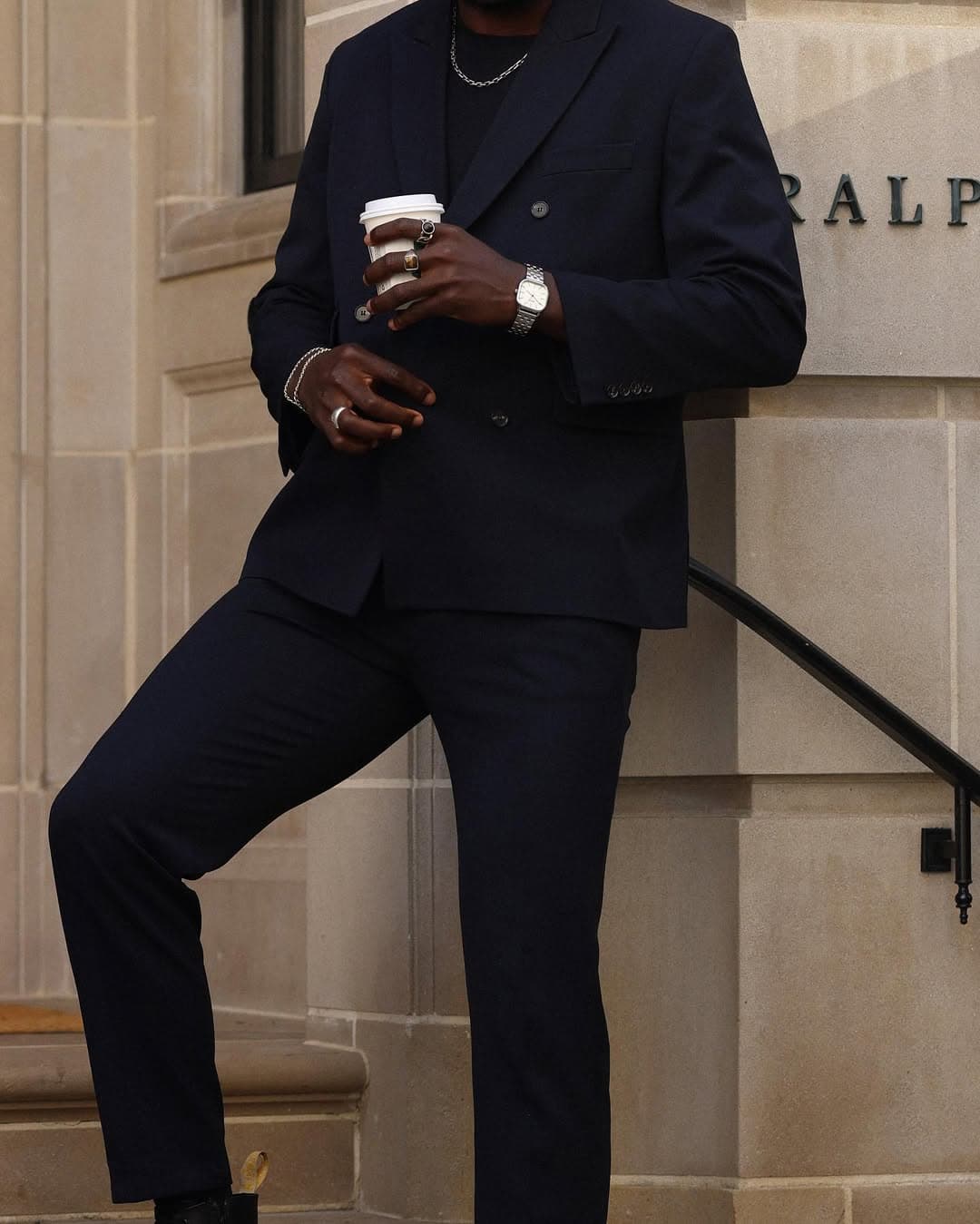 Navy tailoring, coffee in hand